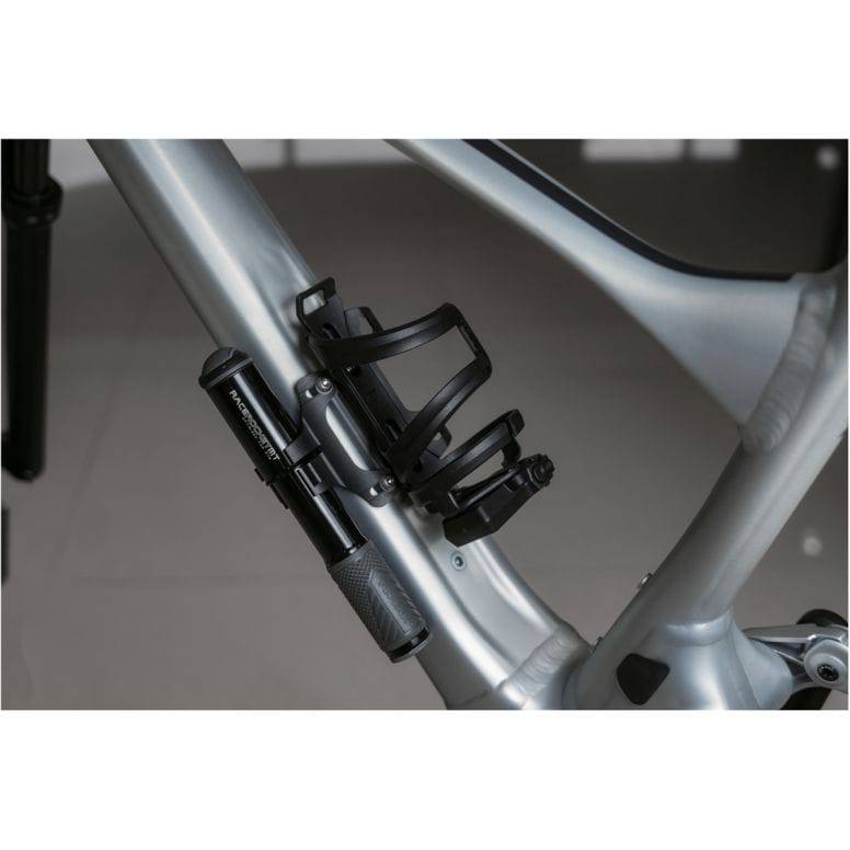 Black Topeak Cage Mount Expander accessory for water bottle cages and pump brackets, attaches securely to bike frame.