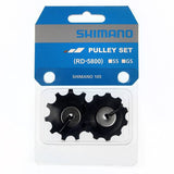 Shimano 105 RD-5800-SS rear derailleur pulley set for smooth shifting, shown in close-up with metal and plastic components.