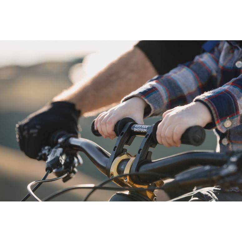Kids Ride Shotgun 2.0 black child bike seat with handlebars, designed for kids' riding safety and comfort.