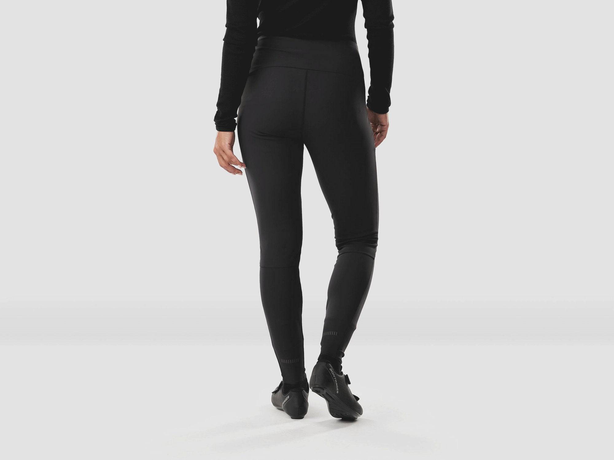 Black Trek Circuit Women's thermal cycling tights, fitted and secure, designed for warmth and comfort during rides.