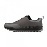 Fizik Terra Ergolace GTX waterproof flat MTB shoes with Vibram outsole, shown in black with textured upper and rugged sole.