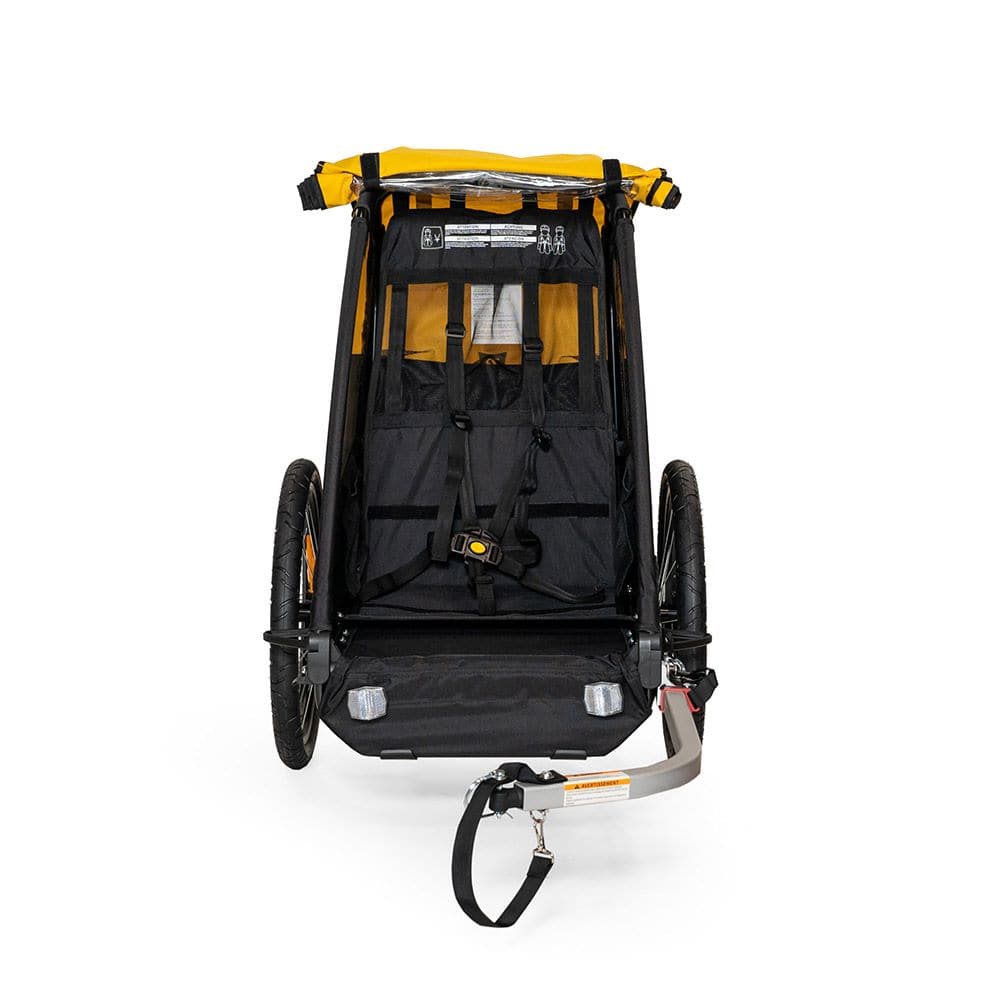 Burley Bee bike trailer with safety harness and weather cover for single child, shown with durable fabric and secure hitch.