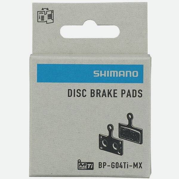 Shimano G04Ti-MX metal sintered disc brake pads with titanium back and spring for mountain bike braking components.