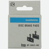 Shimano G04Ti-MX metal sintered disc brake pads with titanium back and spring for mountain bike braking components.