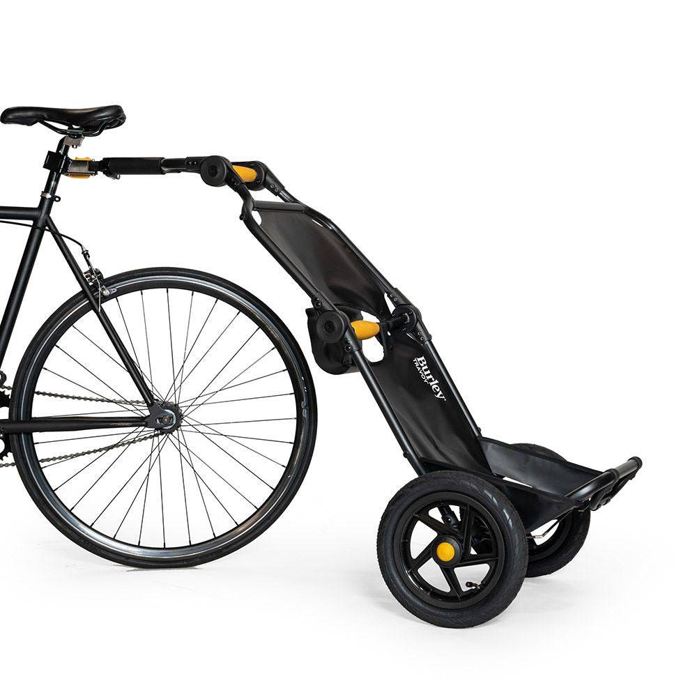 Burley Travoy cargo bike trailer 2024, folding and portable, shown attached to a bicycle for transporting cargo.