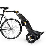 Burley Travoy cargo bike trailer 2024, folding and portable, shown attached to a bicycle for transporting cargo.