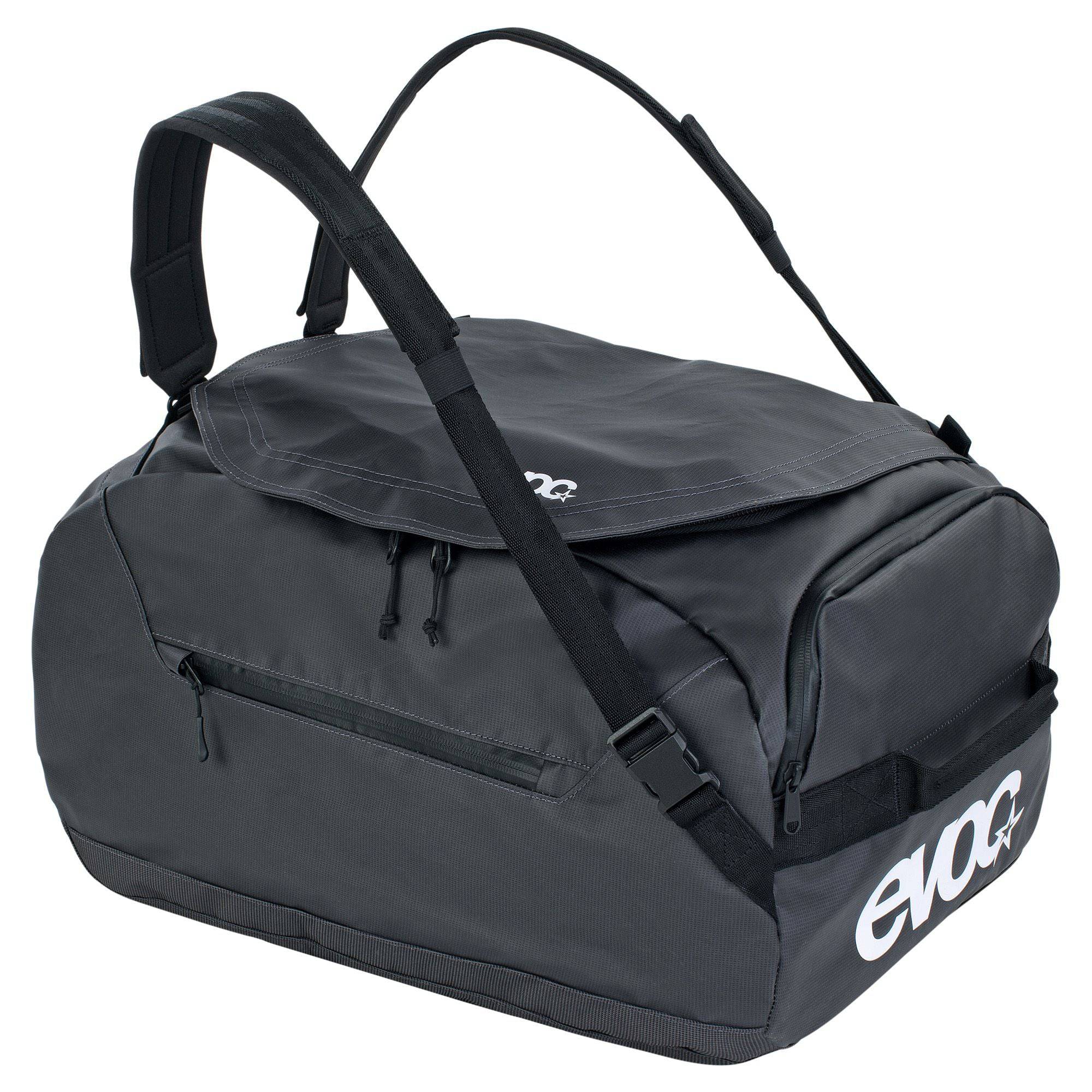 Waterproof EVOC duffle bag with rugged design, 100L capacity, used as a travel pannier and gear bag, showing durable fabric and zippers.