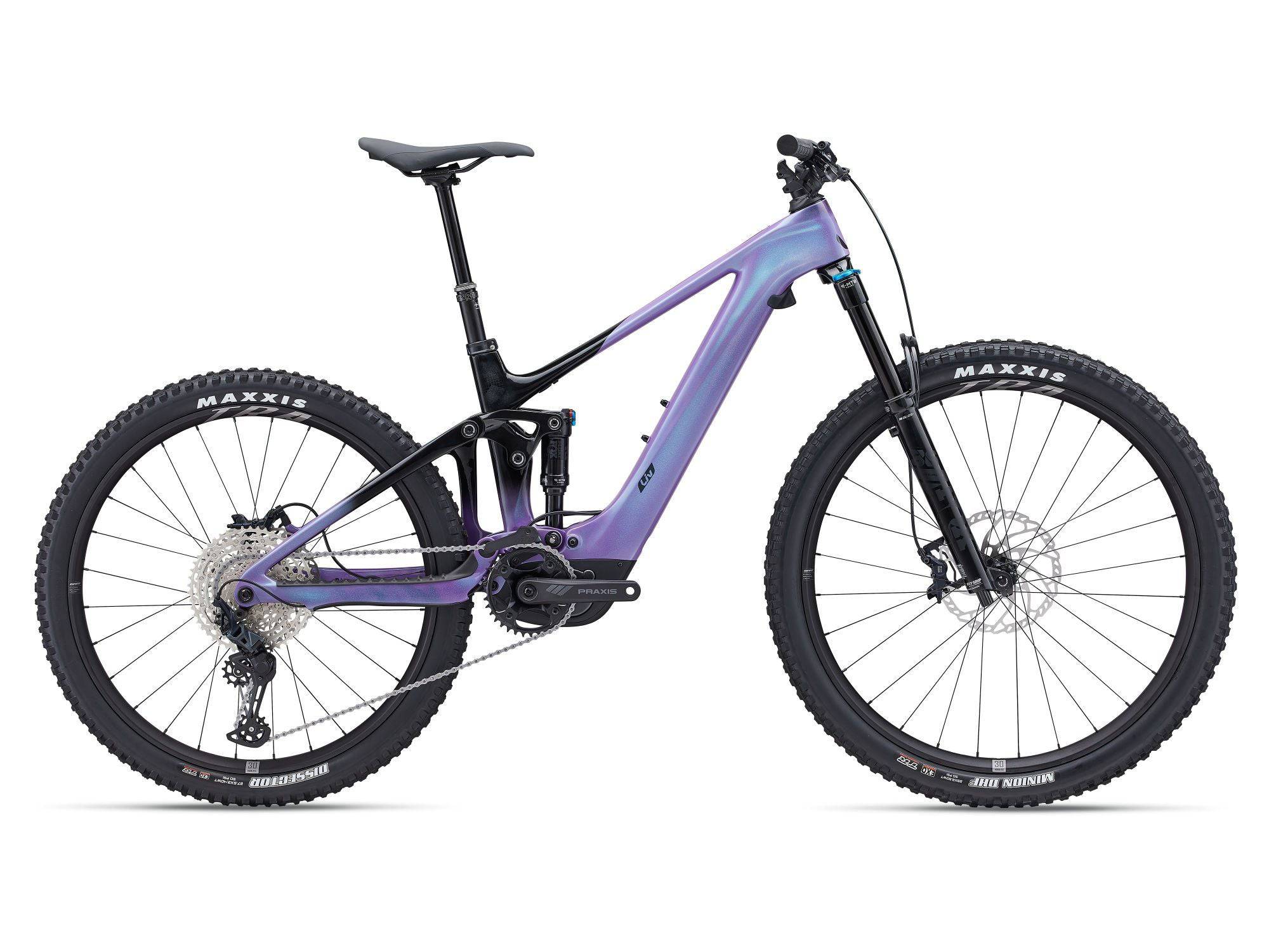 Liv Intrigue X Advanced E+ Elite 2 women’s e-mountain bike with Shimano SLX M7100 drivetrain and full suspension on rugged trail.