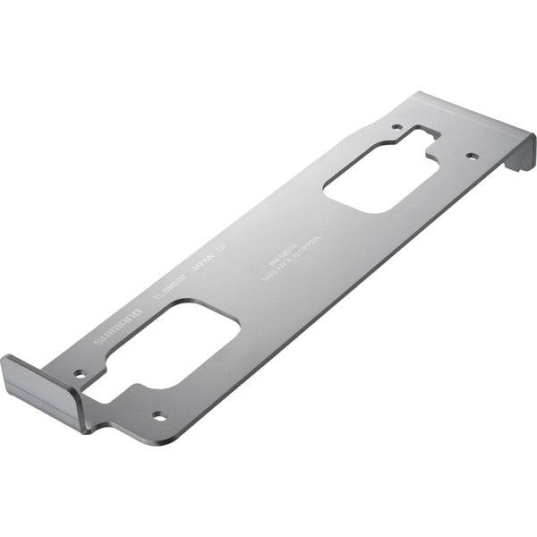 Shimano TL-BME02 battery mount setting tool for BM-E8010 e-bike systems, shown on a workbench with workshop tools.