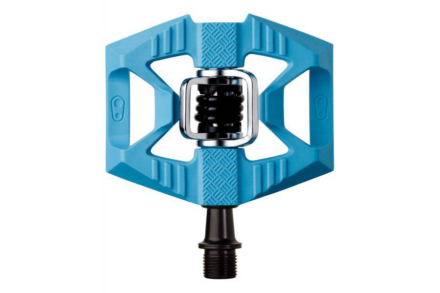 Crank Brothers Double Shot 1 hybrid clipless and flat pedal with adjustable cleats, shown from a side angle on a bike pedal platform.