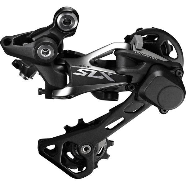 Shimano SLX RD-M7000 GS 11-speed Shadow+ rear derailleur for mountain bikes, shown mounted on a bike drivetrain.