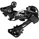 Shimano SLX RD-M7000 GS 11-speed Shadow+ rear derailleur for mountain bikes, shown mounted on a bike drivetrain.
