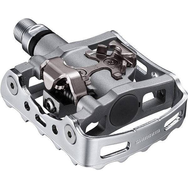 Shimano PD-M324 SPD MTB pedals with one-sided clipless and flat design, showcasing durable cycling component for mountain biking.