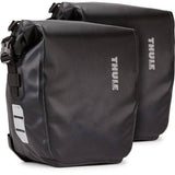 Pair of Thule Shield waterproof bike pannier bags with reflective panels, designed for touring and commuting cycling accessories.