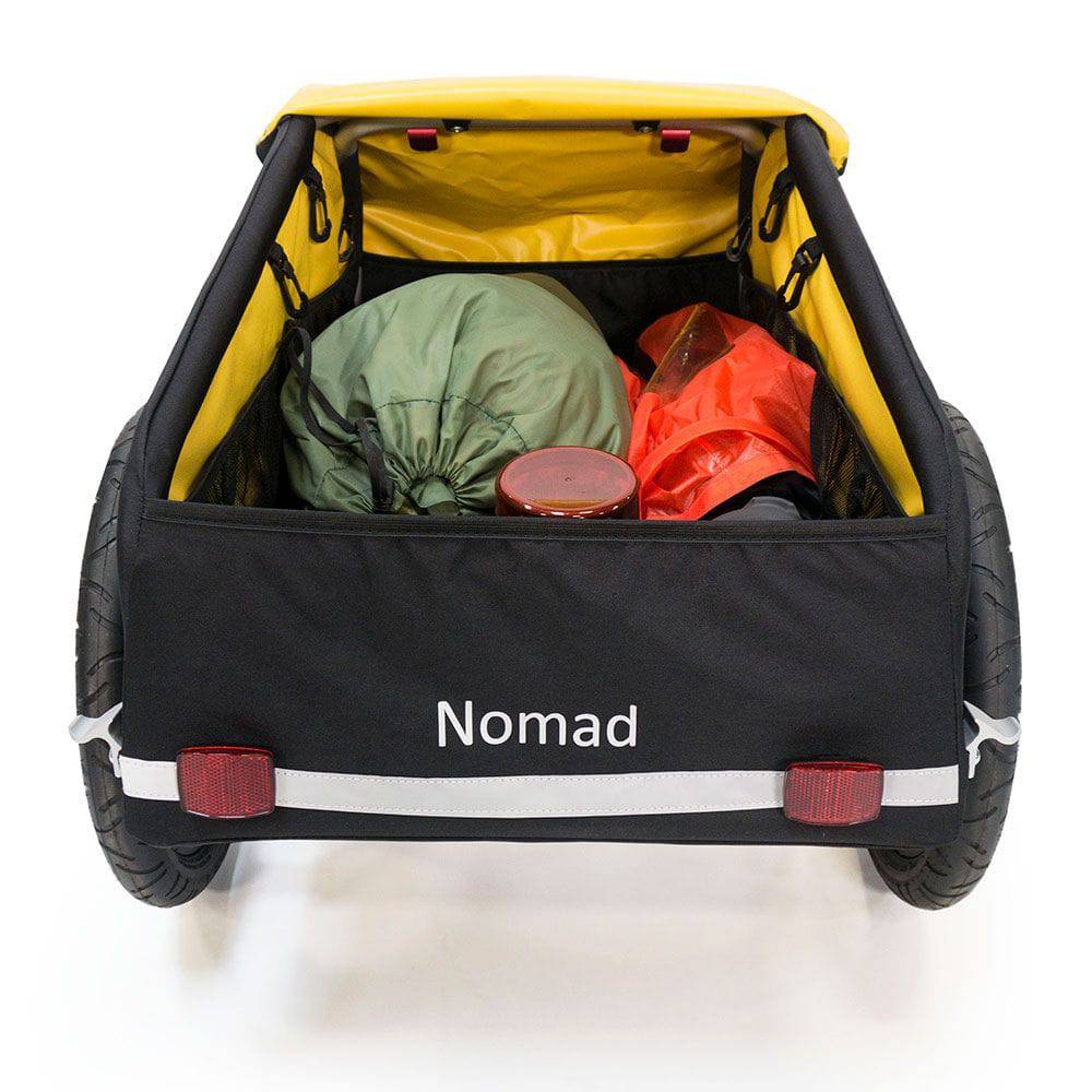 Burley Nomad cargo bike trailer with water-resistant cover, foldable design, showcasing sturdy frame and spacious interior for carrying items.