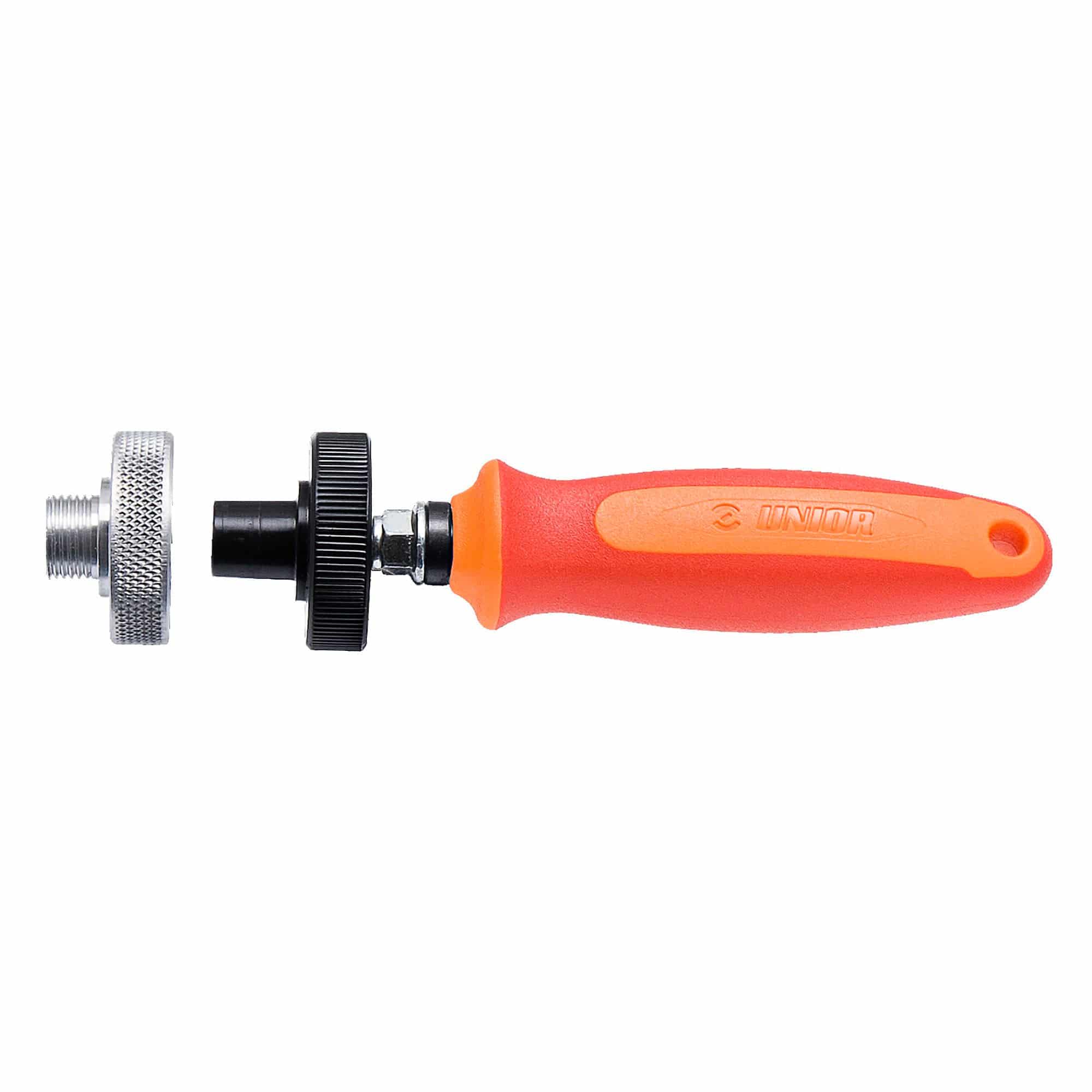 UNIOR Pedal Genie Red bicycle derailleur adjustment tool with adaptors, used in workshop for precise gear tuning.