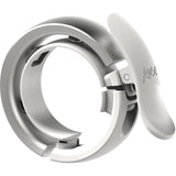Knog Oi Prima bike bell with Wave-Tek technology and cable management, mounted on a bicycle handlebar.