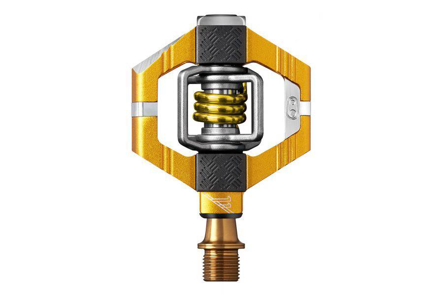 Crankbrothers Candy 11 Gold clipless mountain bike pedals with premium bearings, shown mounted on a bike.