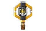 Crankbrothers Candy 11 Gold clipless mountain bike pedals with premium bearings, shown mounted on a bike.