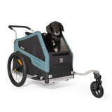 Burley Bark Ranger pet trailer with stroller kit, showing the bike and walk trailer for pets, in a natural outdoor setting.