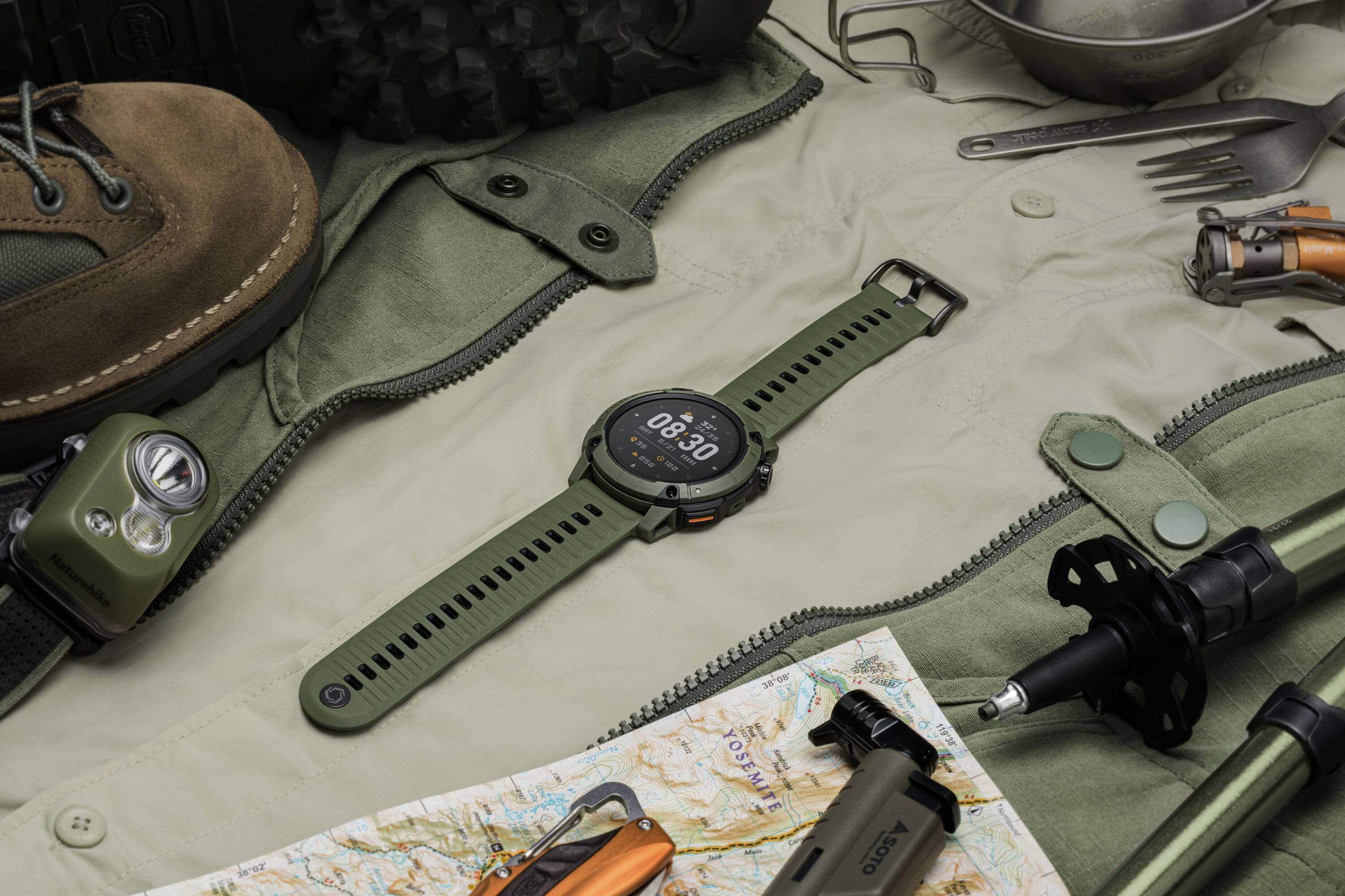 Coros Nomad outdoor GPS watch with green strap, showing adventure journal and multiple sport modes on digital display.