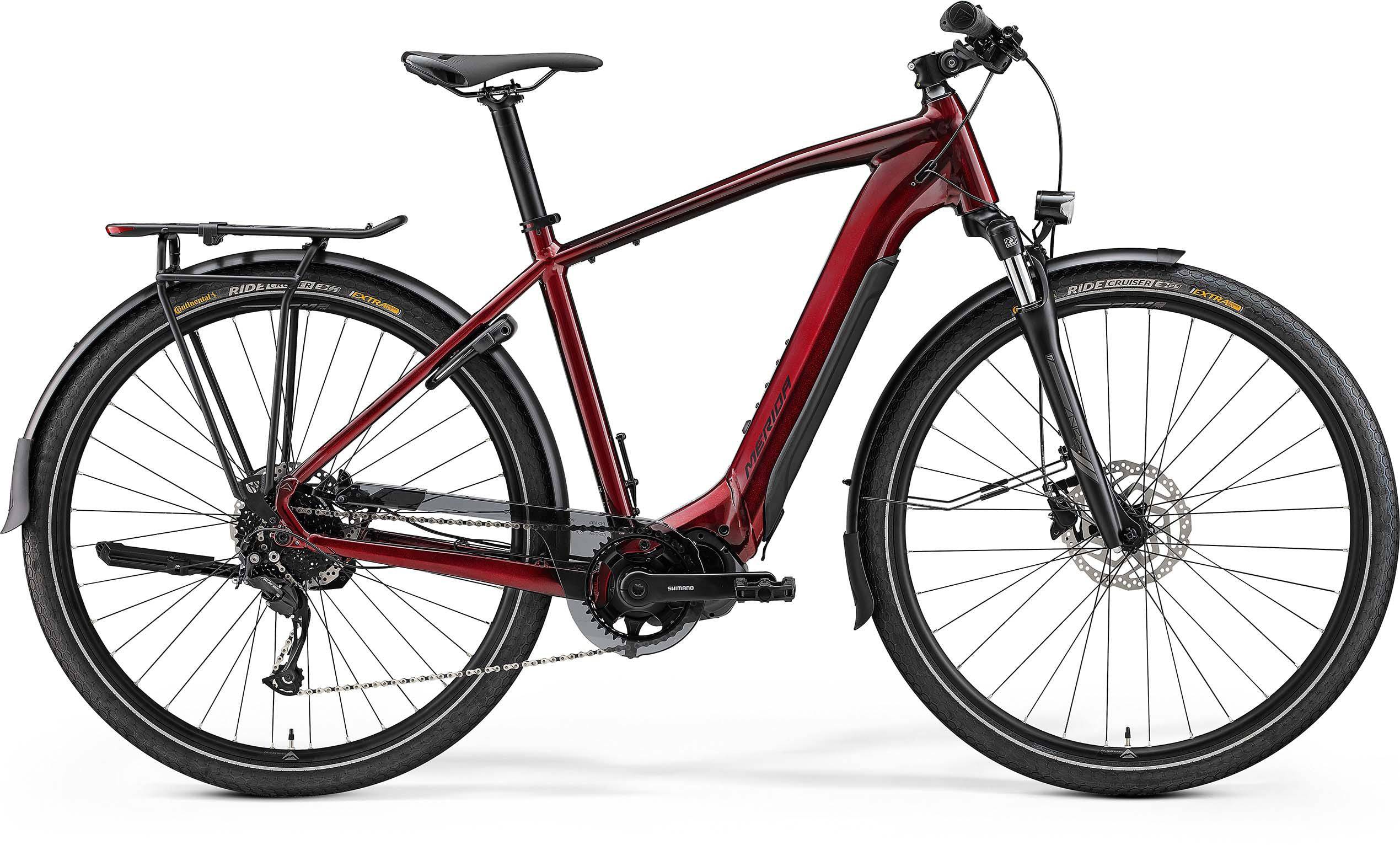 Merida eSpresso 400 S EQ electric hybrid bike with integrated lights, rack, and mudguards, shown with a sleek frame and features.