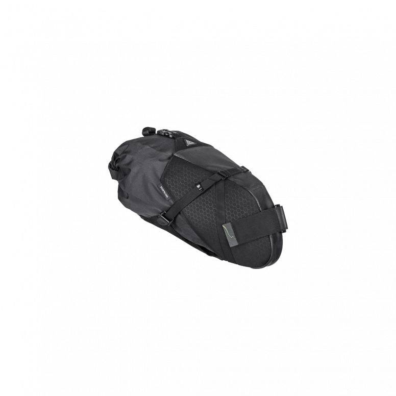 Black Topeak Backloader X 10L waterproof bikepacking seat bag with light strap mounted on a bike saddle.