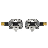 Look X-One-G Ti gravel racing pedals with SPD compatibility and adjustable tension, showing lightweight titanium construction and cleat engagement.