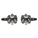 Look X-Track Race Carbon MTB pedals with SPD clipless mechanism and 60mm platform, shown with sleek black design and cleats attached.