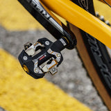 Look X-Track Race Carbon Ti MTB pedals with adjustable SPD cleat tension, lightweight carbon construction, and durable metal clips.