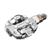 Look X-Track Power single MTB and gravel pedals with integrated power meter, black metal components for cycling performance.