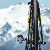 Look Keo 2 Max Carbon road bike pedals with wide platform and adjustable tension, shown with cleats attached on a cycling shoe.
