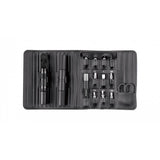 Topeak Ratchet N Roll Elite black compact bike repair toolkit with CO2 inflator on workshop workbench, organized with tools and accessories.