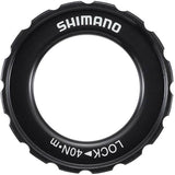Shimano Spares HB-M618 lock ring and washer for hub assembly maintenance, shown in close-up on a bicycle hub.