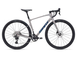 Giant Revolt Advanced 1 2024 gravel bike with SRAM Apex groupset and disc brakes, shown from a side angle on a trail.