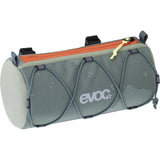 EVOC Handlebar Roll Upcycle Bag in random color, eco-friendly bike accessory mounted on bike handlebars.