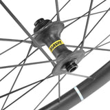 Mavic Cosmic Ultimate Centre Lock disc wheelset with carbon rim for road cycling, featuring aero spokes and hub detail.