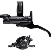 Shimano Deore XT M8200 brake lever and post mount caliper set for mountain biking, black finish, mounted on a bike.