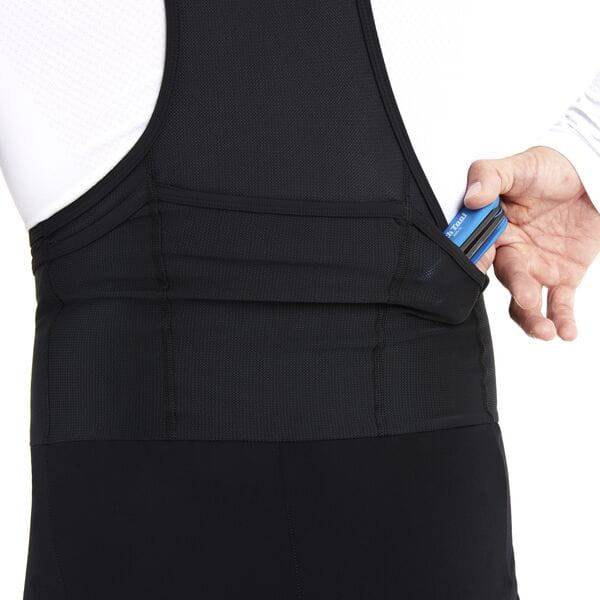 Madison Roam men's DWR water-repellent cargo bib tights with multiple pockets, designed for outdoor activities and weather resistance.