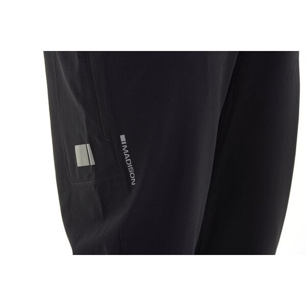 Madison Freewheel men's trousers in dark fabric, showing a close-up of the waistband and front pockets.