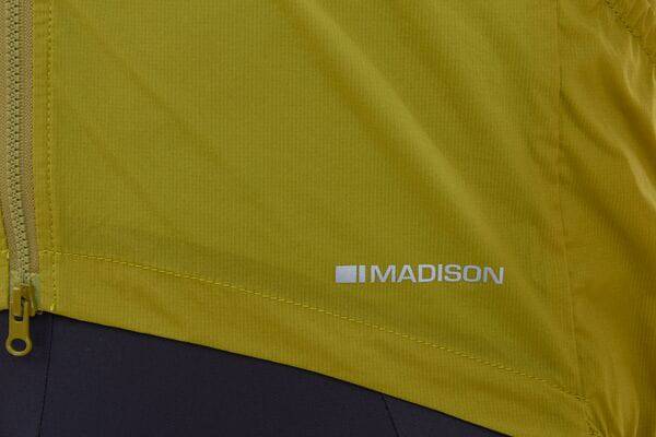 Madison Roam men's windproof packable Primaloft insulated gilet vest hanging on a hanger, showing front view and lightweight design