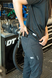 Madison Roam Workshop men's DWR cargo trousers with stretch fabric and knee pad compatibility, shown in dark color.