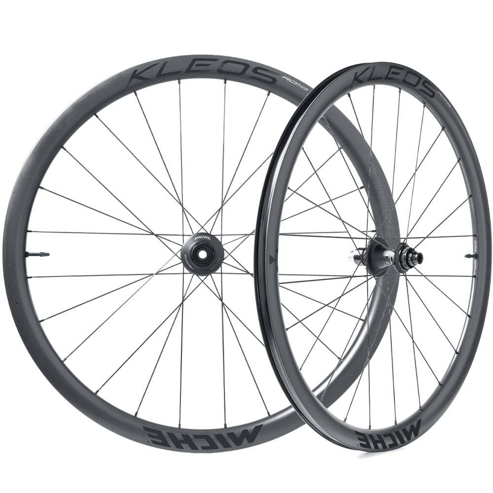 Miche Kleos RD 36mm tubeless road wheel with aerodynamic design and ceramic bearings, showcasing sleek black carbon rims and spokes.
