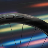 Miche Kleos RD 36mm tubeless road wheel with aerodynamic design and ceramic bearings, close-up of wheel rim and spokes.