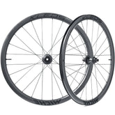 Miche Kleos RD 36mm tubeless road wheel with aerodynamic design and ceramic bearings, showcasing sleek black carbon rims and spokes.