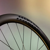 Miche Kleos 42 tubeless road disc brake wheel showing lightweight carbon rim and disc brake interface for high-performance cycling.
