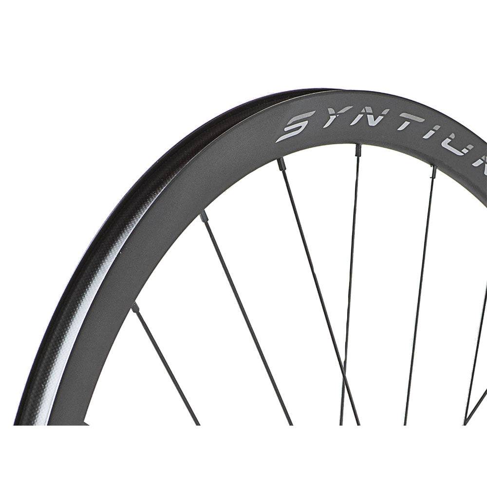 Miche Syntium Aero road wheelset with asymmetric 29mm tubeless-ready wheels, showing close-up of black alloy rims and spokes.