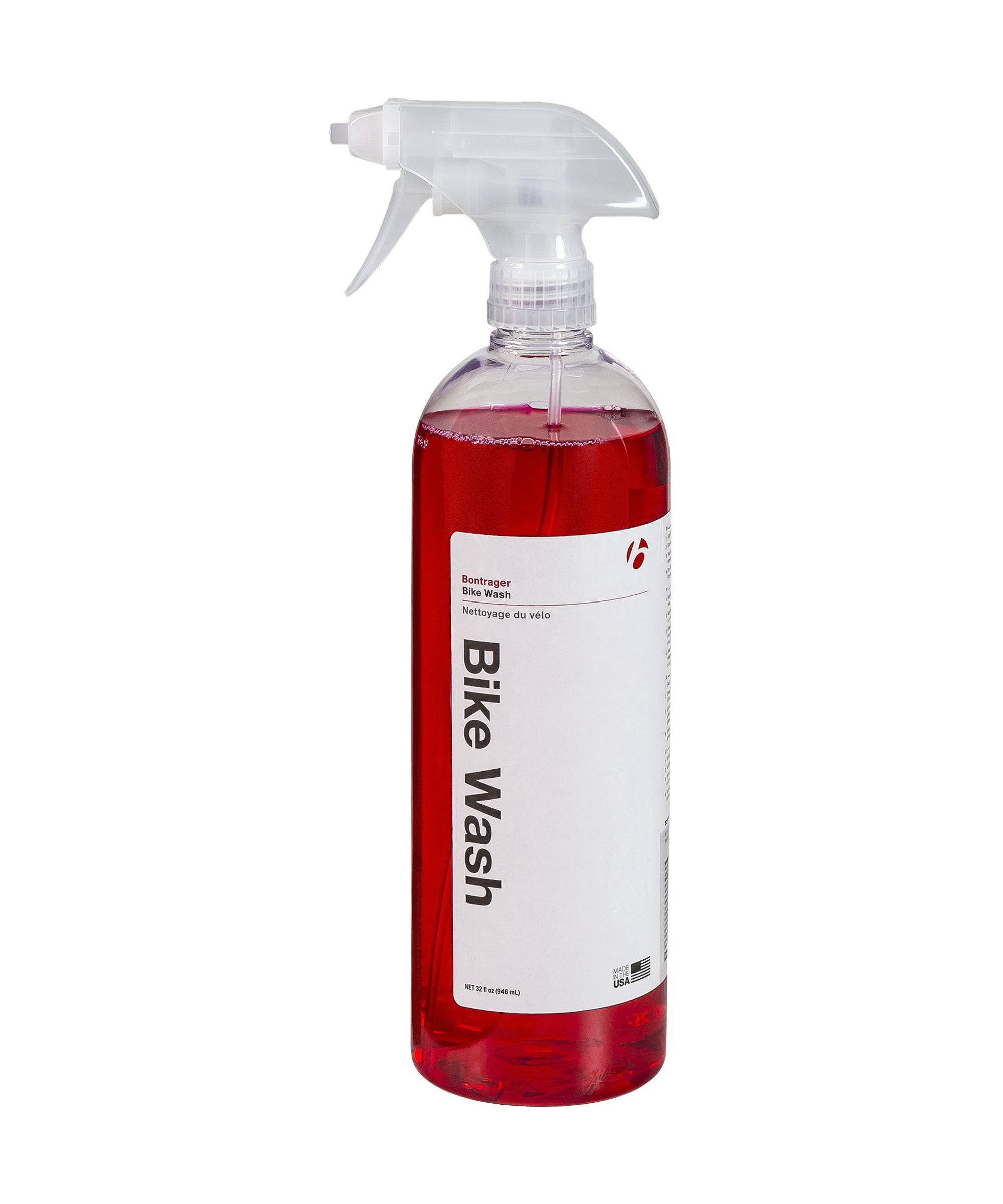Bontrager Bike Wash Spray 32oz in a workshop setting, safe cleaner for all bike paints and surfaces, with spray bottle and bike parts.