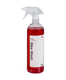 Bontrager Bike Wash Spray 32oz in a workshop setting, safe cleaner for all bike paints and surfaces, with spray bottle and bike parts.