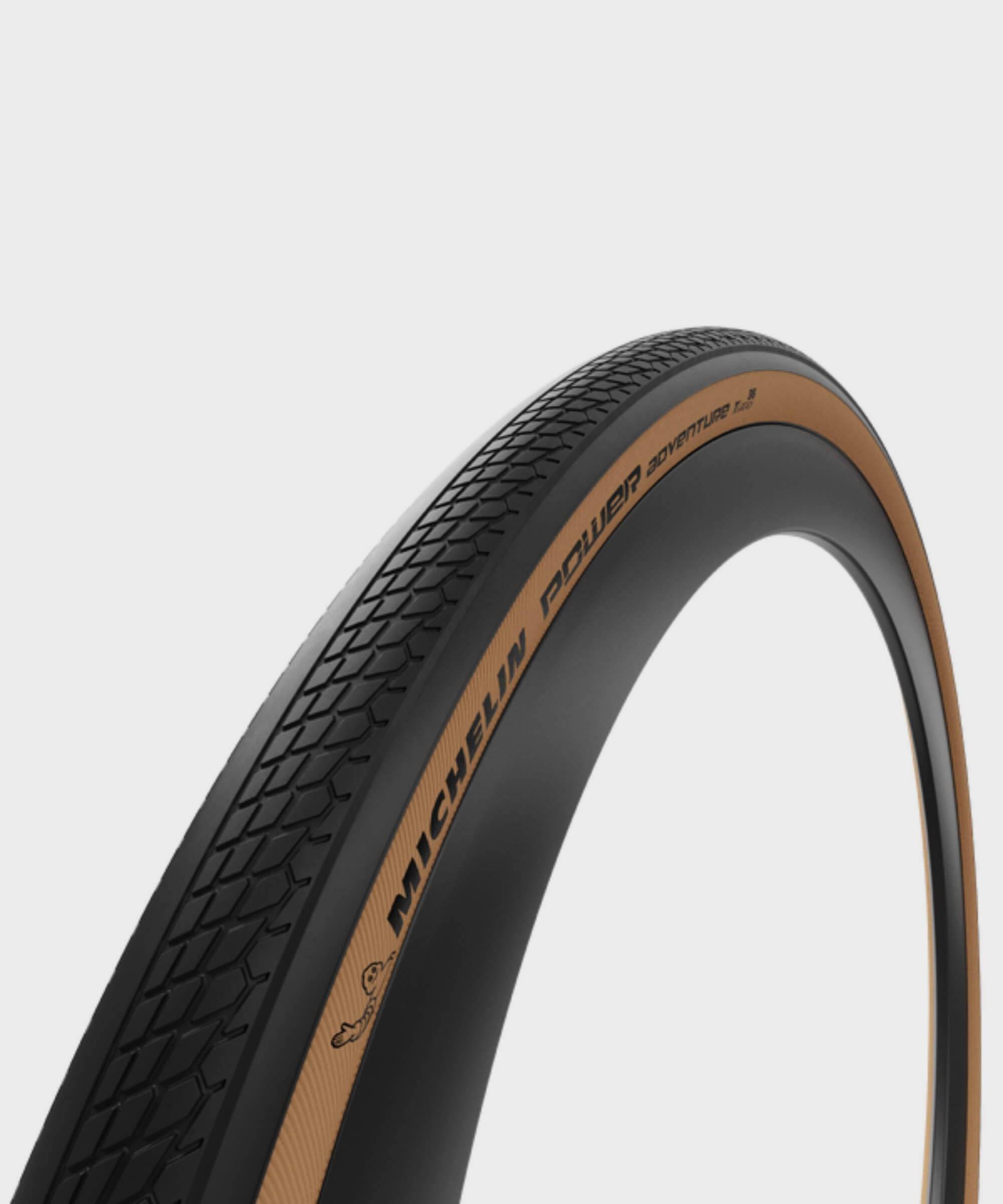 Michelin Power Adventure gravel tyre tubeless-ready with puncture protection, shown mounted on a bicycle wheel.